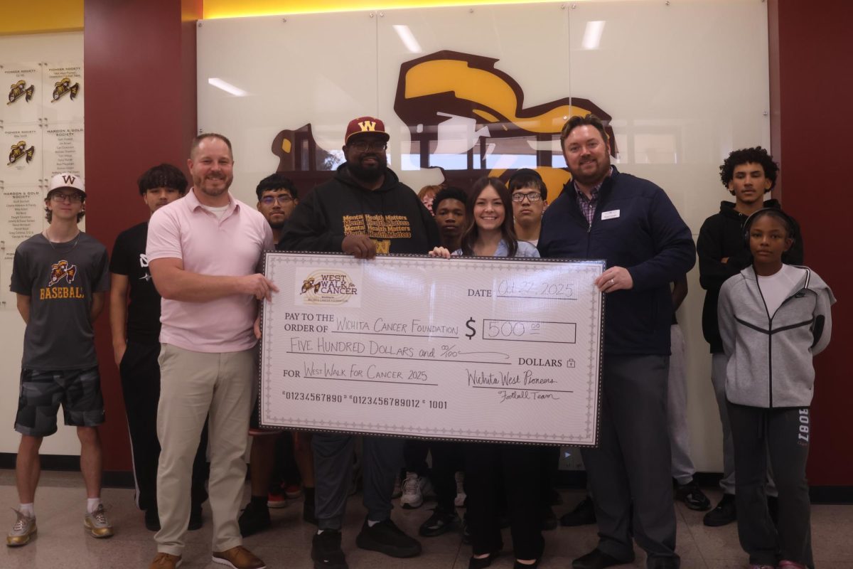 Students and Staff holding up a $500 check