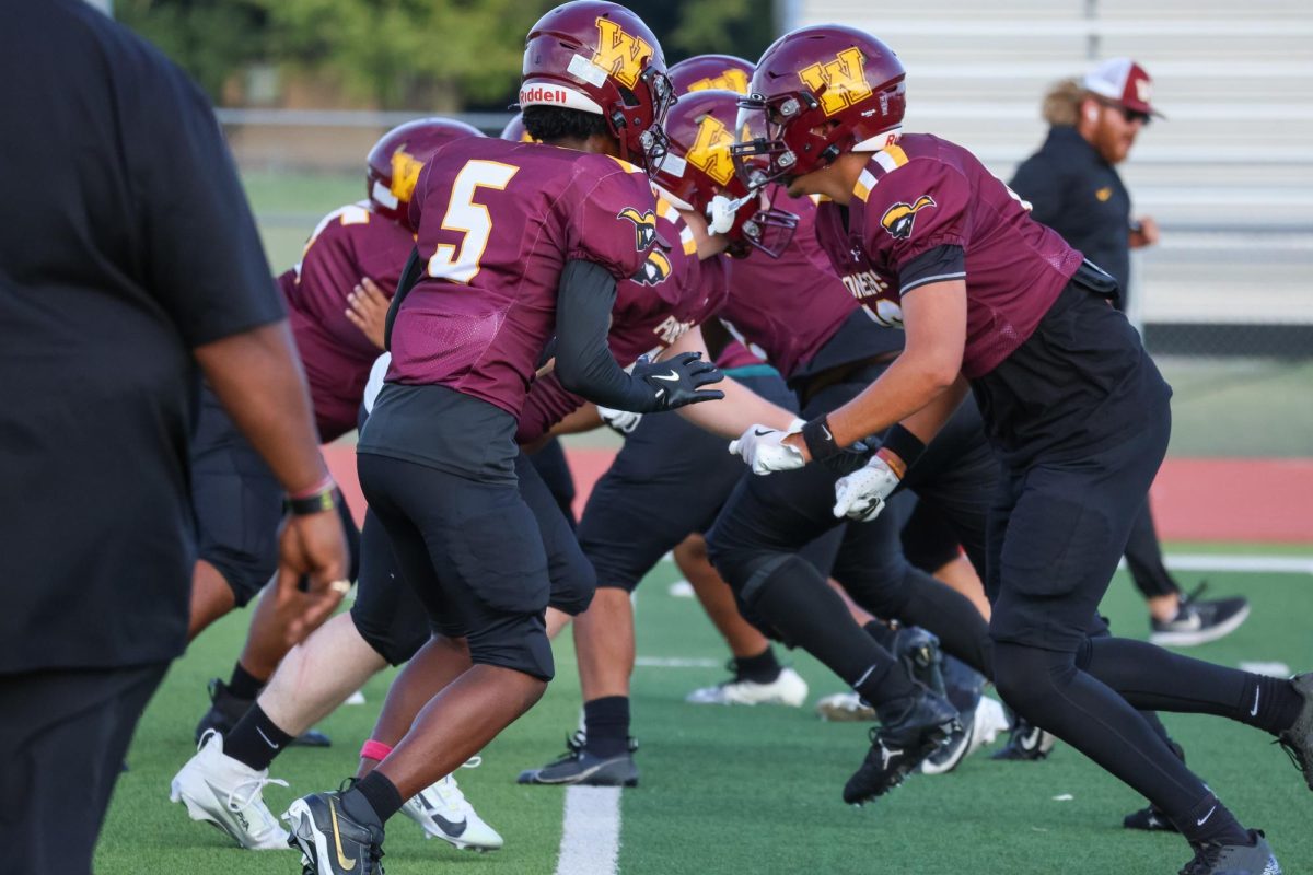 Pioneer football team running a scrimmage before the game against Wichita North High.